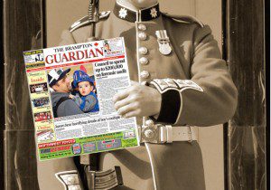 The Brampton Guardian newspaper held my solider in uniform in black and white photo