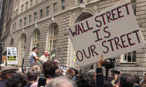 Protest with sign saying "Wall Street is Our Street"