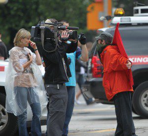 Camerman and citizen wearing red