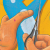 Illustration of hands cutting out twitter logo