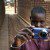 Woman holds camera in brick alleyway