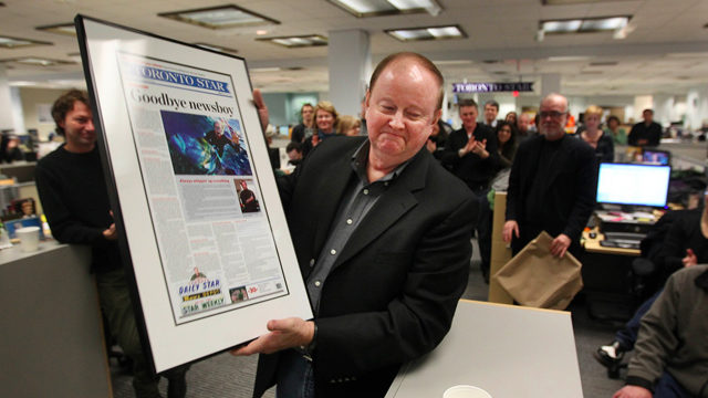 Toronto Star "Goodboy newsboy" article framed held by man