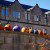 Painted pumpkins on a wall in front of large building