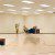 Man in large empty office room at his desk