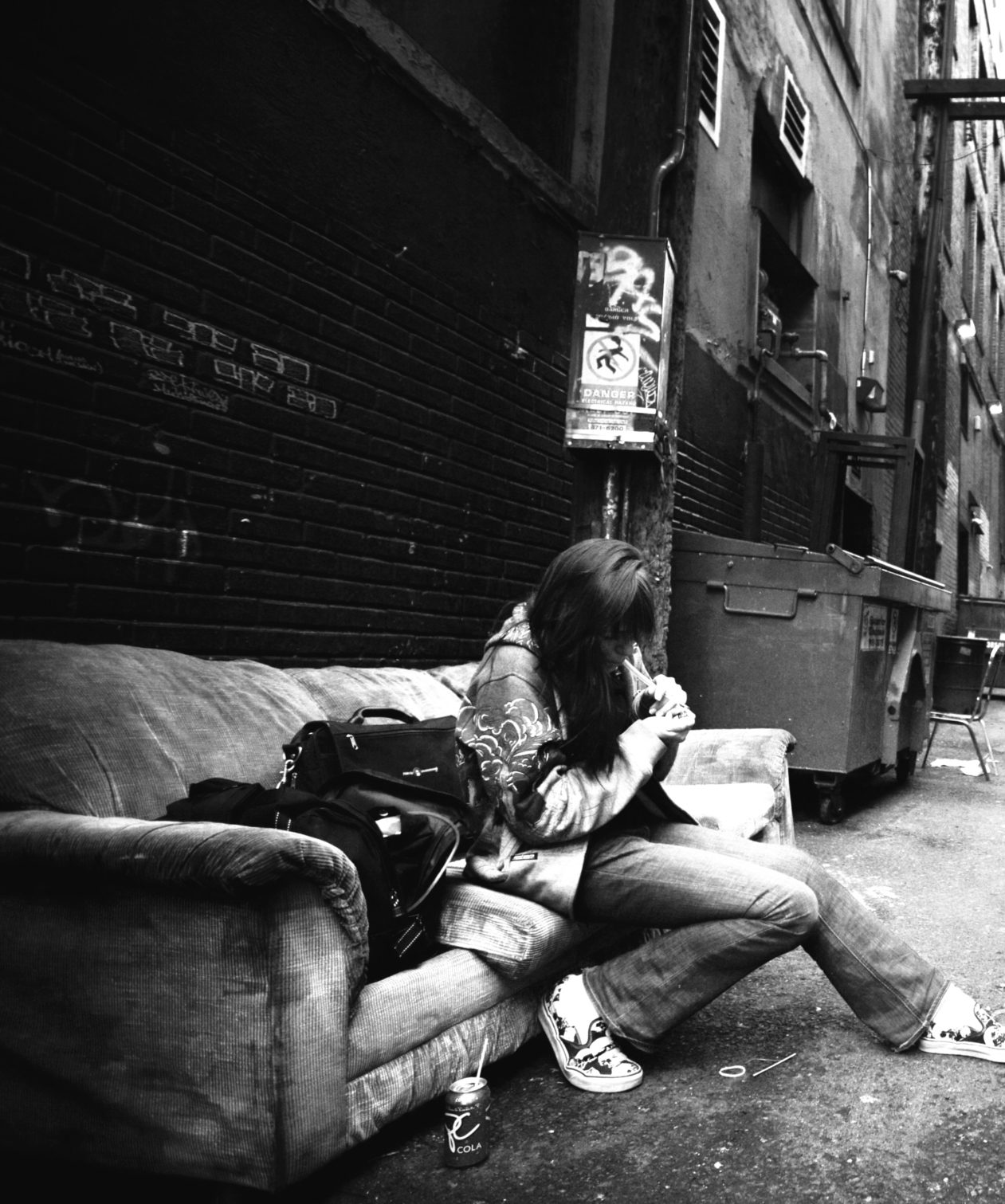 Woman on couch in alley