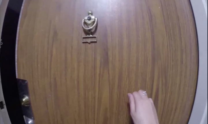 Hand knocking on door, fisheye image