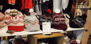 Toques printed with the names of Toronto neighbourhoods sit on a shelf at the Spacing Store in Toronto
