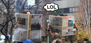 Women reading newspapers bubble from one woman says "LOL"