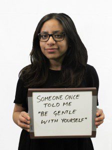Woman holds whiteboard "Someone once told me 'Be gentle with yourself'"