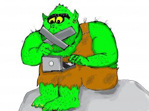 A green troll types on a laptop while his mouth is taped up.