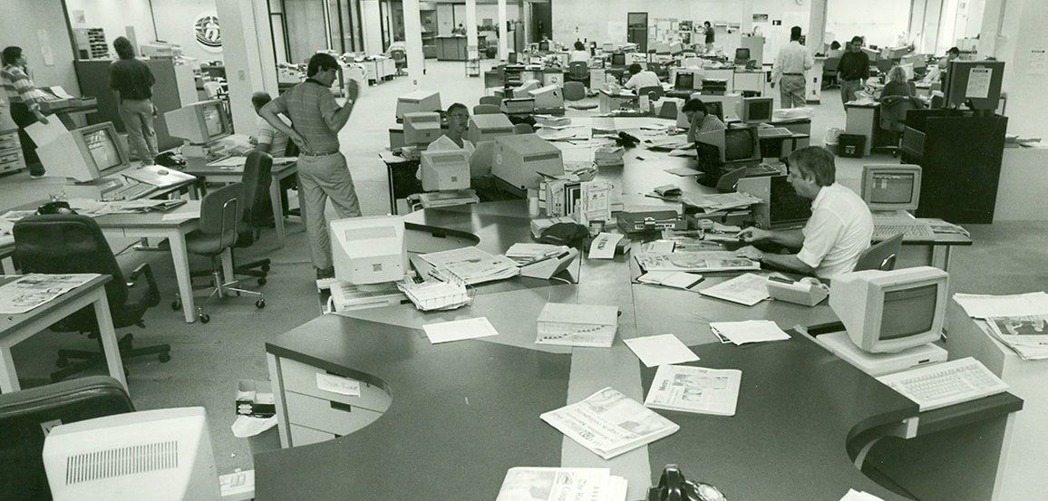 People working in newsroom