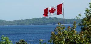 Canadian flag by lake