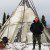 Man stands in front of teepee