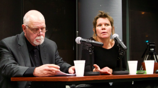 Robert Washburn and Gretchen King speaking at a podium