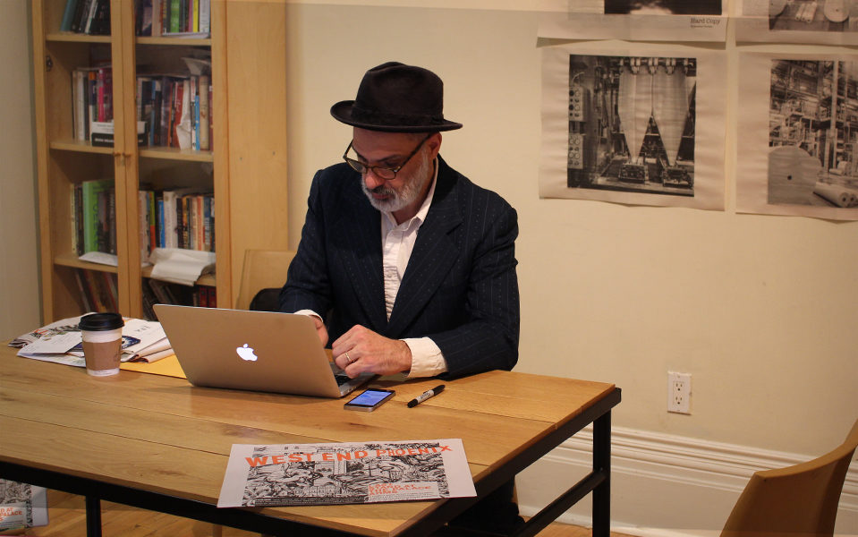 Dave Bidini on a laptop at a desk