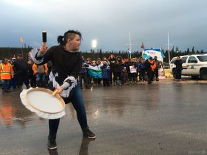 A woman drums during an anti-fracking protest.