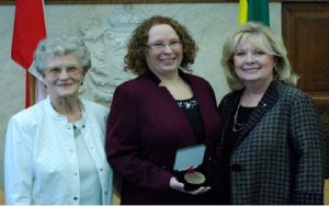 Alison Squires (middle) and co-recipient Marge Headington (left) receive the Senate 150 Medal from Senator Pamela Wallin (right). (Andy Labdon/Supplied)