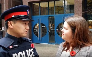 Toronto police Const. Victor Kwong, left, and spokeswoman Meaghan Gray in a Nov. 2, 2017 episode of TPS News. (Toronto Police Service/YouTube)