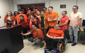 First-year journalism students at the College of the North Atlantic pose in themed gear for Orange Shirt Day, an annual event that recognizes the harm of residential schools in Canada.