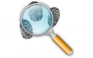 A magnifying glass examining finger prints
