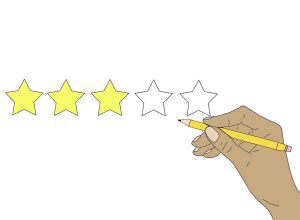 A hand fills in stars for a review