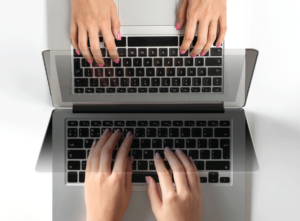 Descriptive image of hand typing on a keyboard